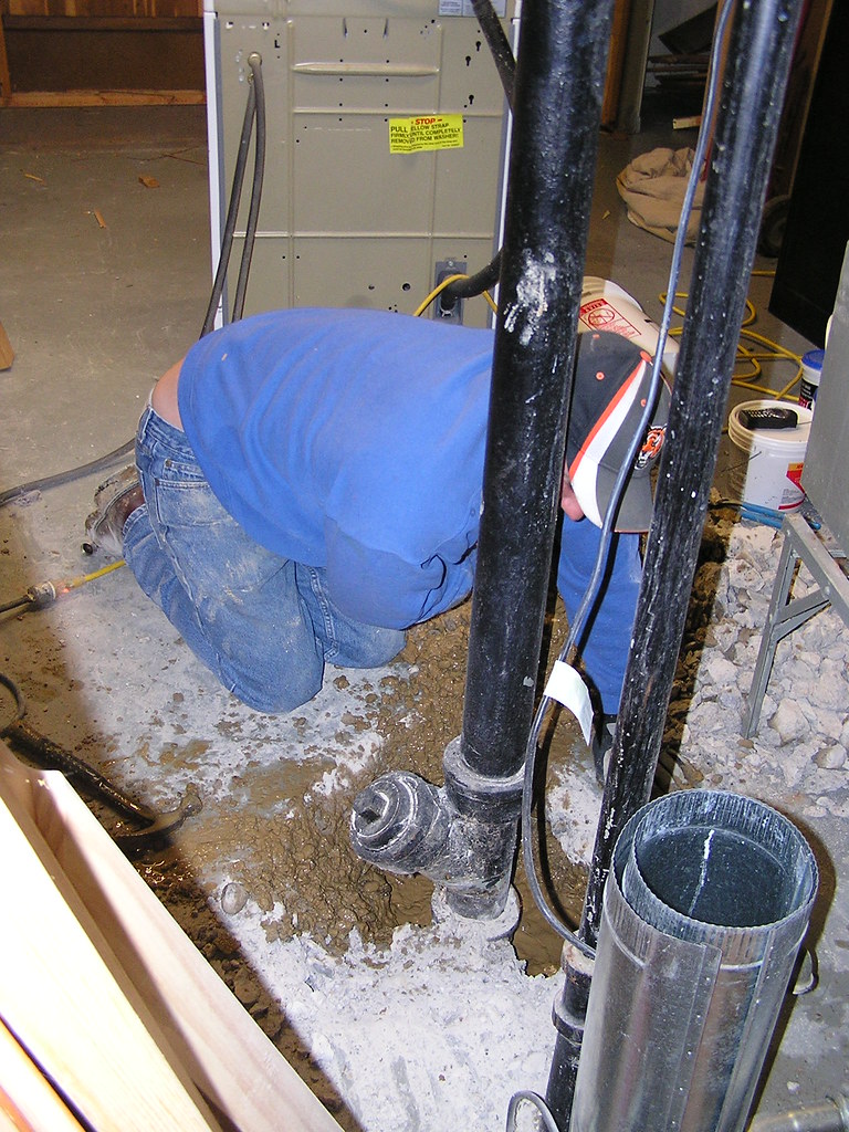 Licensed plumber working on pipework